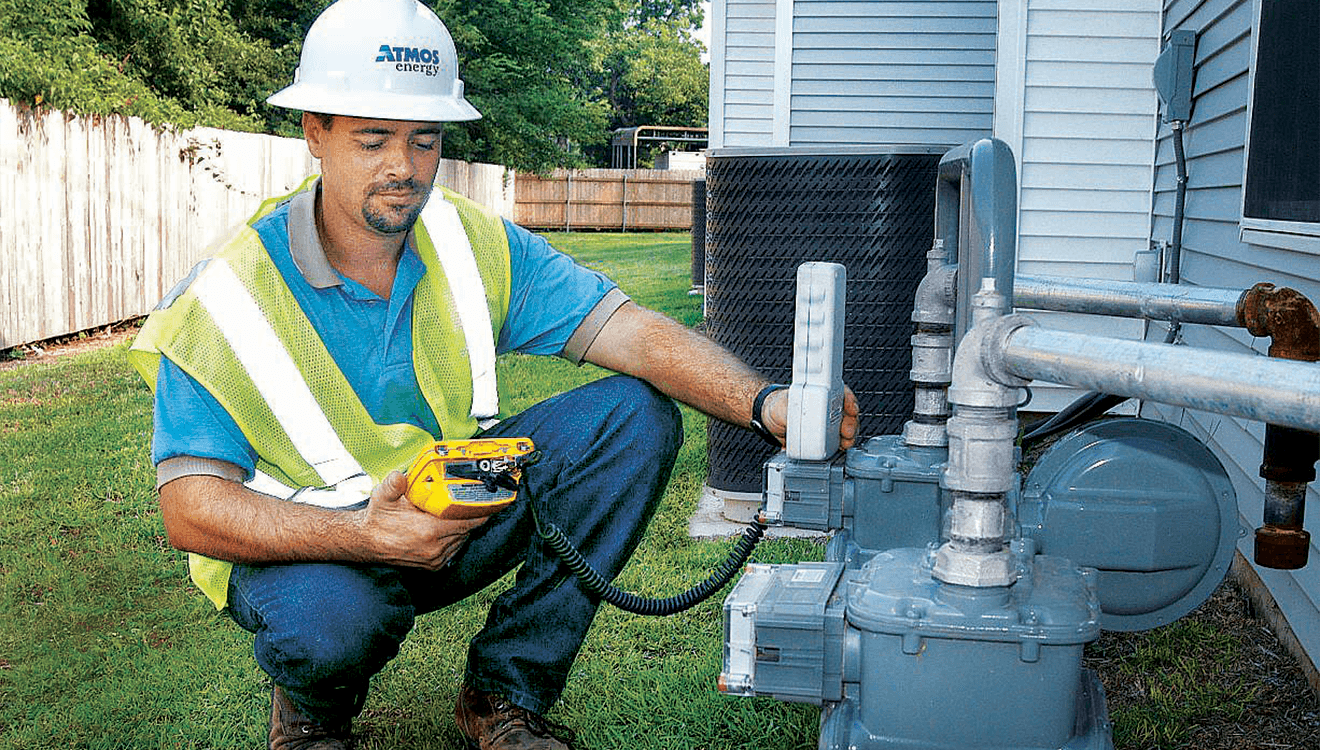 Meter reader at a customer's natural gas meter using a device to measure the customer's gas consumption.