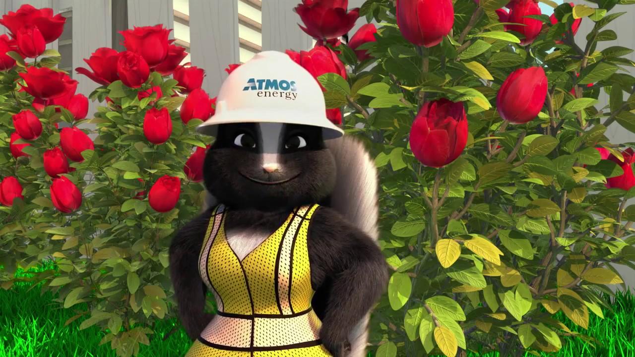 Rosie the Skunk in front of flowers with an Atmos Energy hard hat on