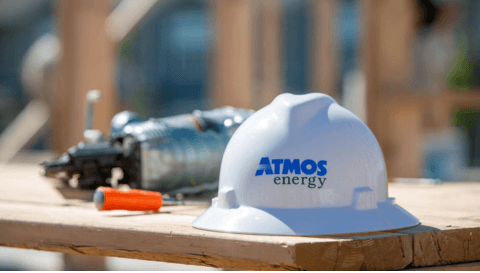 Atmos Energy hard hat on table at a construction site